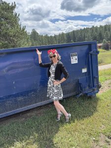 Sally Ball stands next to a dumpster that she speaks about in this blog.